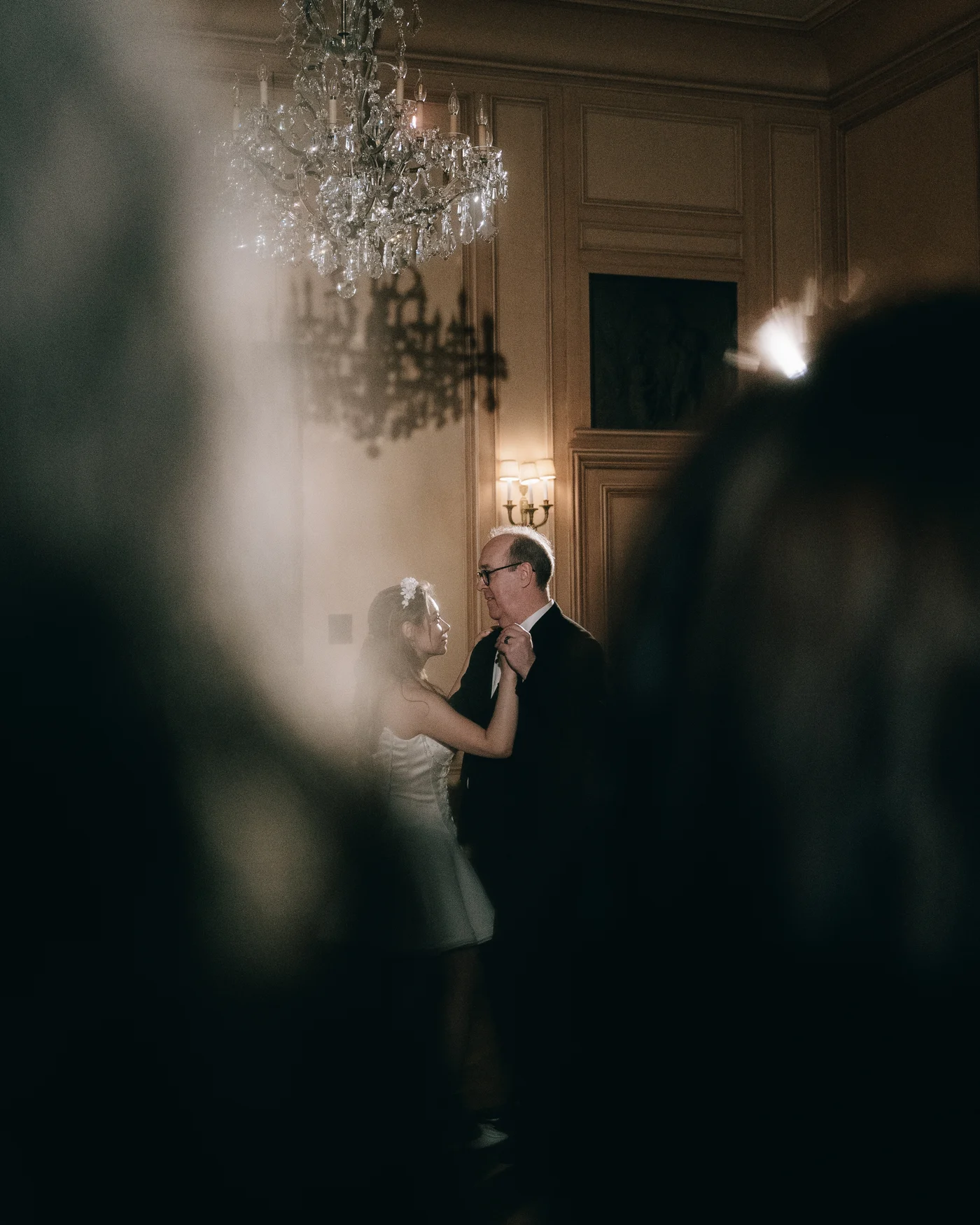 A guest through the blur of a chandelier
