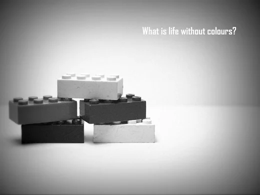 Five LEGO bricks stacked in black and white, captioned What is life without colours