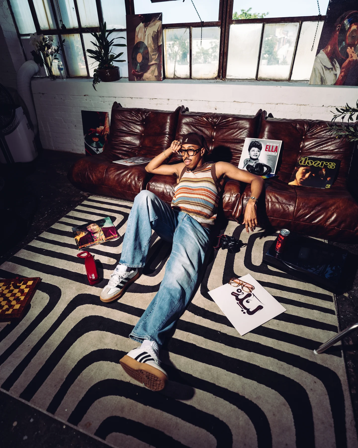 Kyle sprawled on the sofa with one arm behind his head, a magazine on the rug