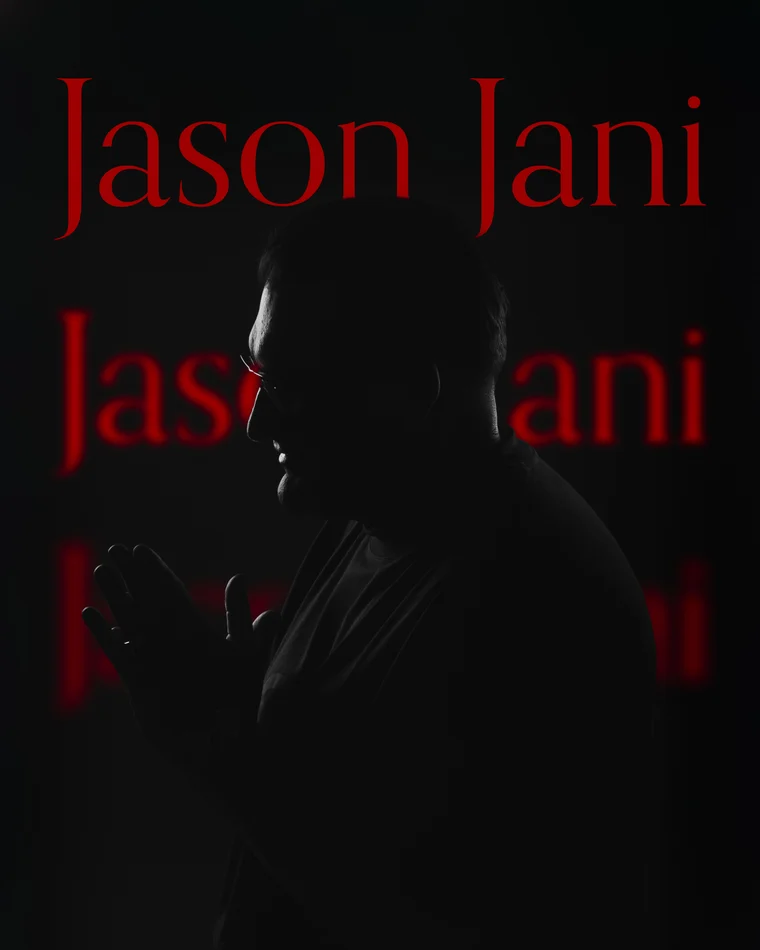 A man in profile in near darkness, his name lettered in red and repeated down the backdrop behind him