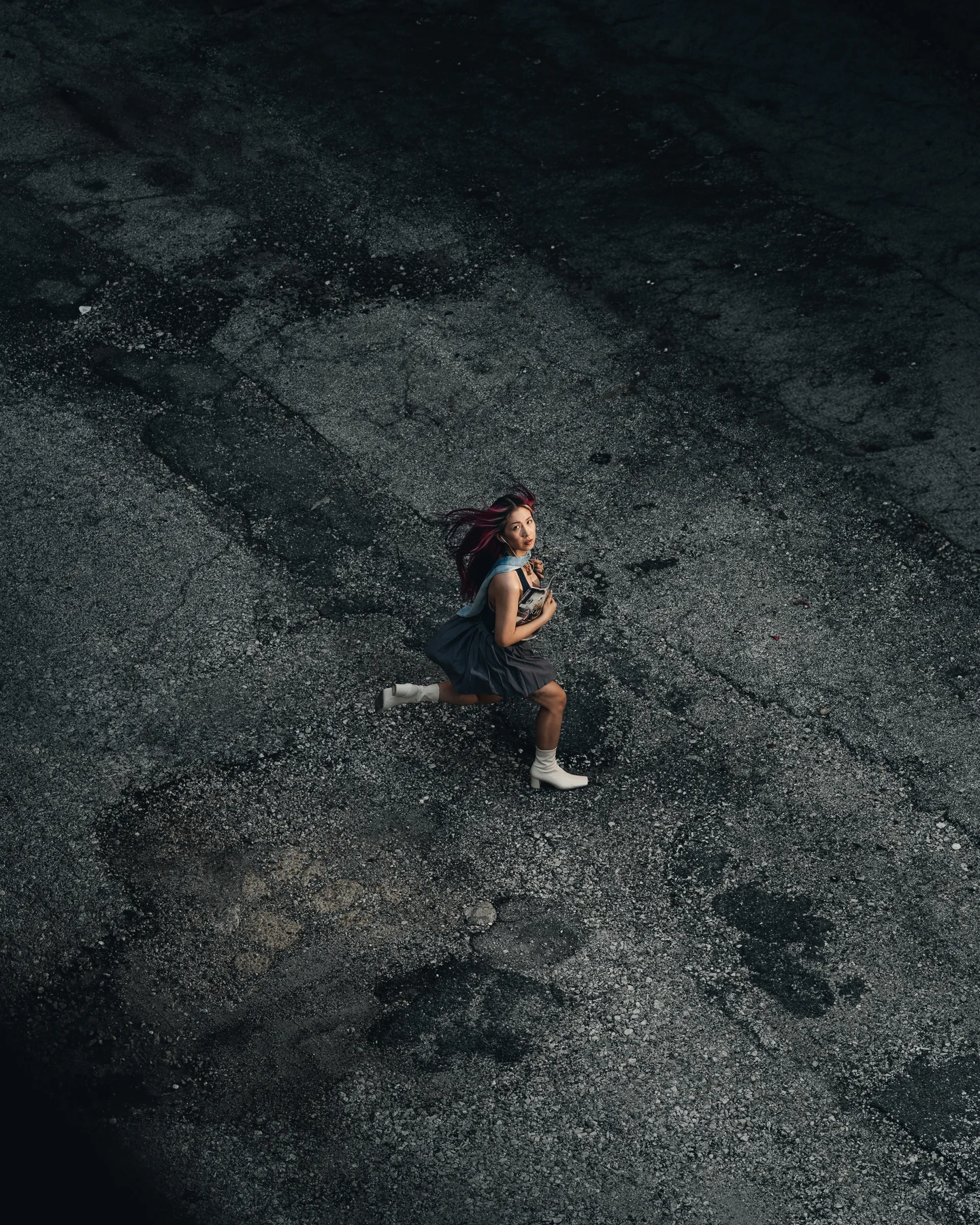 Overhead of the same lot, the figure small against the dark ground