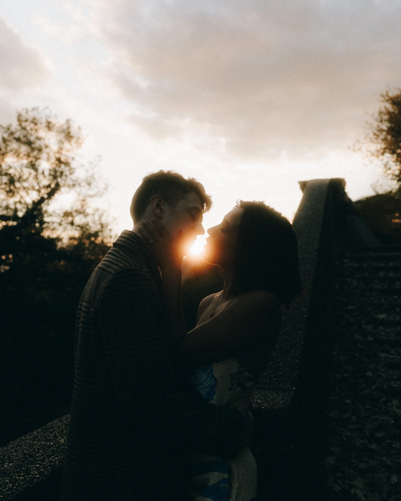 Nose to nose at sunset, the sun burning through the narrow gap between their faces