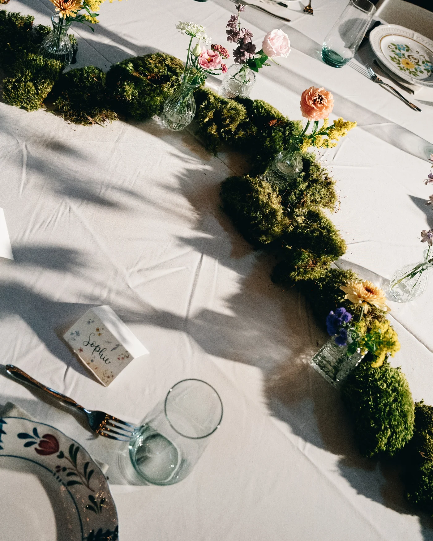 The ceremony arch dressed in flowers against a blue sky