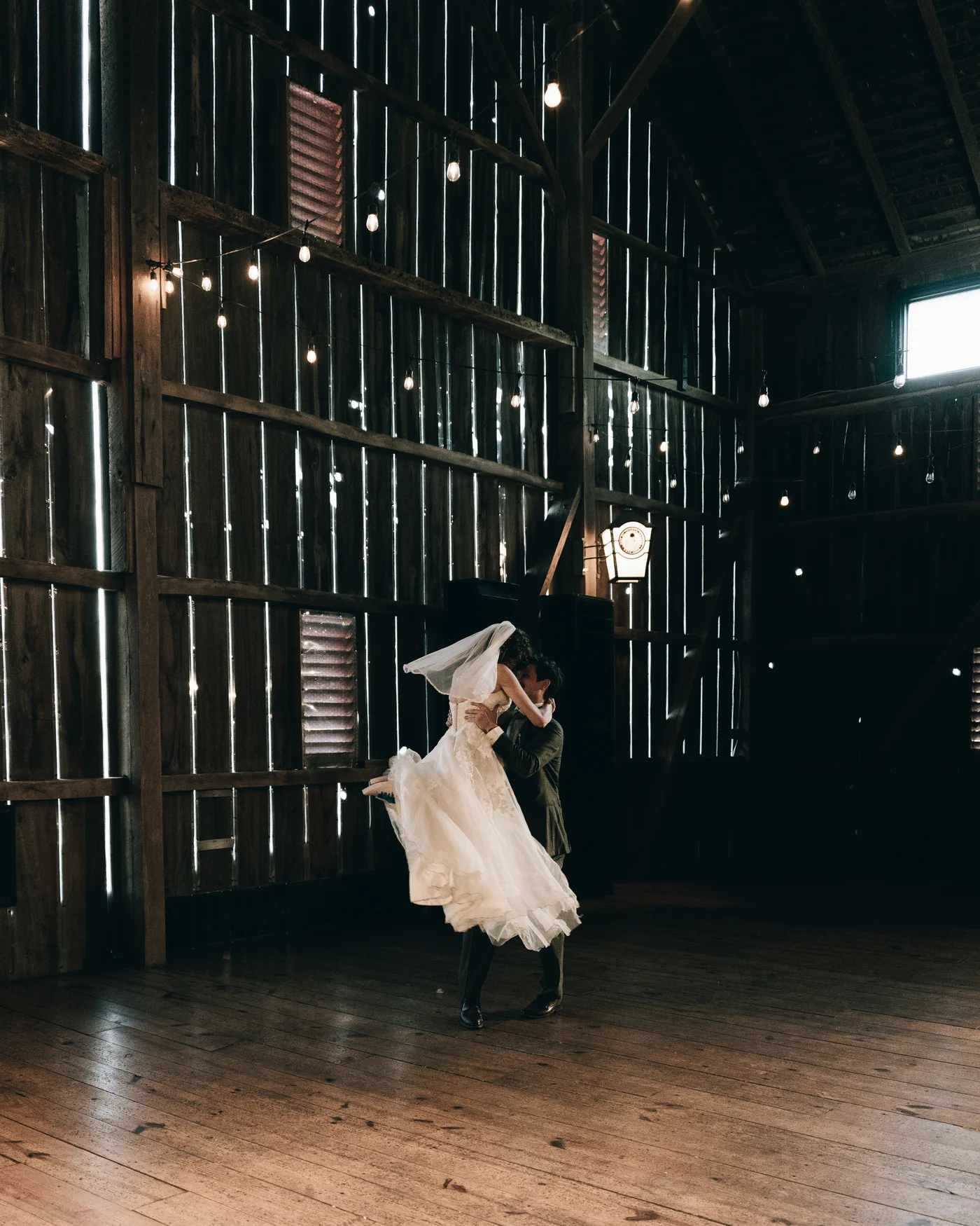 The bride spinning on the barn floor, her gown flying out