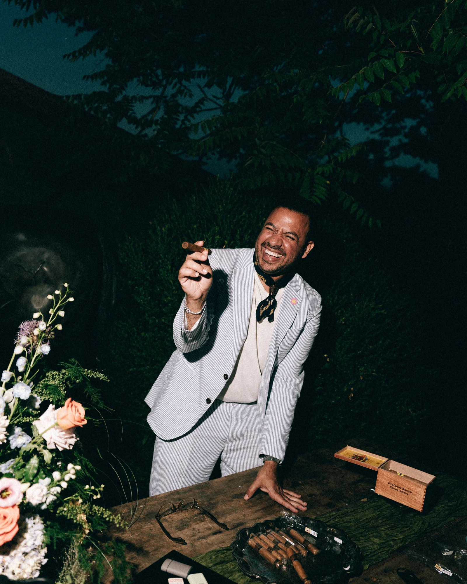 A guest in a white dinner jacket working the DJ table